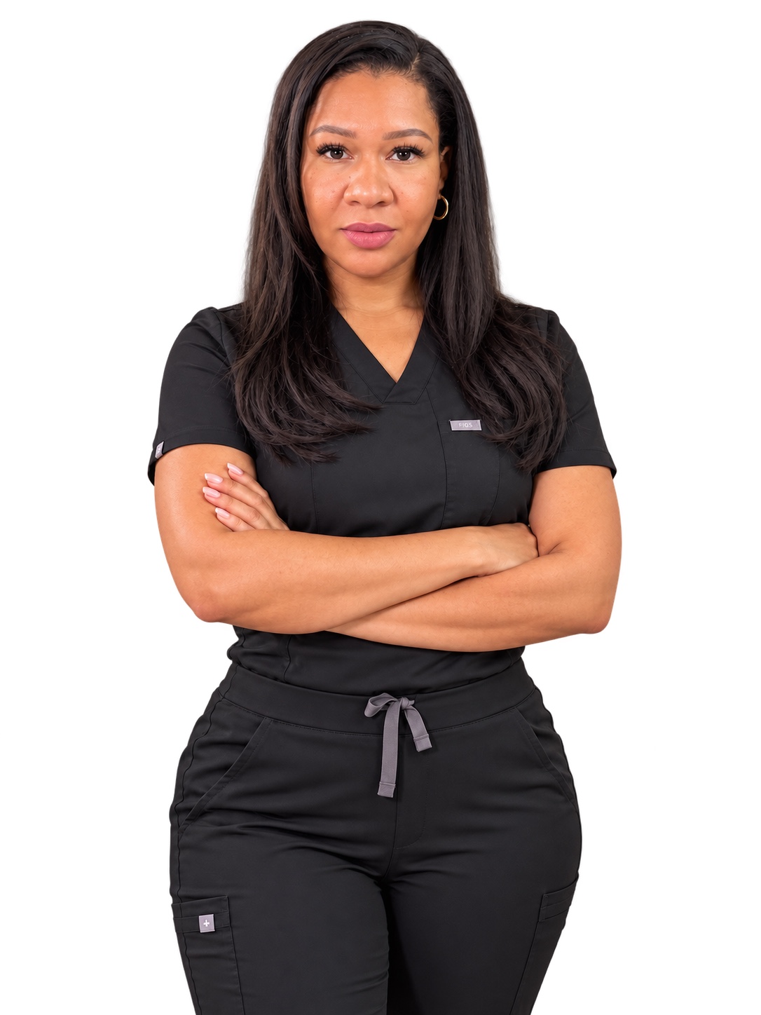 Riça in black scrubs with her arms crossed